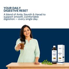 A woman in a light green kurta holds a glass of brown herbal juice behind a table displaying a bottle and box of Triphal Digesto Care Juice (for Digestive wellness inn men and women) against a dark blue background with promotional text.