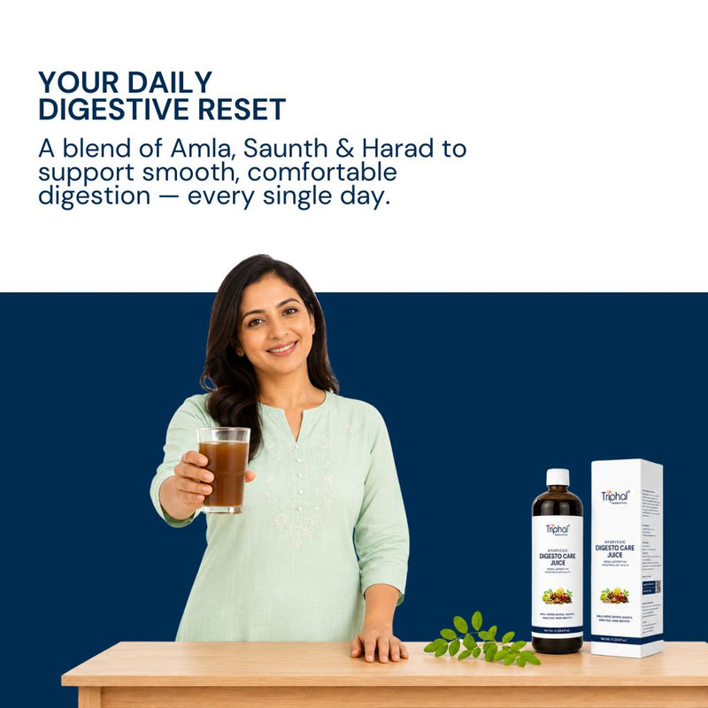 A woman in a light green kurta holds a glass of brown herbal juice behind a table displaying a bottle and box of Triphal Digesto Care Juice (for Digestive wellness inn men and women) against a dark blue background with promotional text.