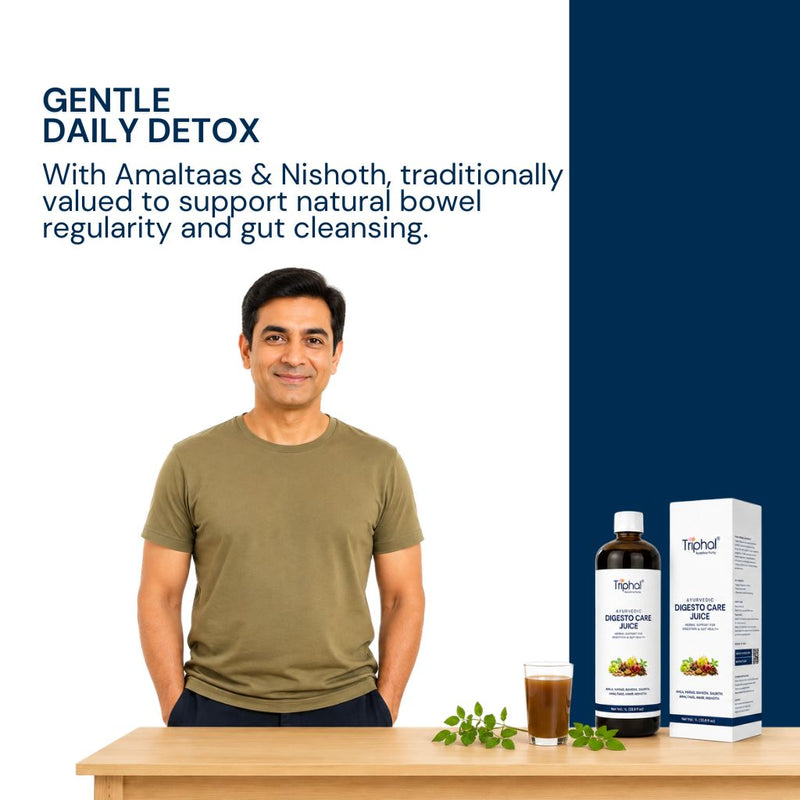 A man in an olive green t-shirt stands behind a wooden table displaying a bottle and box of Triphal Digesto Care Juice alongside a glass of the dark liquid and green leaves. The left side has text reading 'GENTLE DAILY DETOX' on a split white and dark navy background.