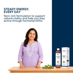 A woman in a light purple embroidered kurta stands behind a wooden table with a bottle and box of Triphal's Gyno Support Juice for Women Wellness on a white and navy promotional background with marketing text.