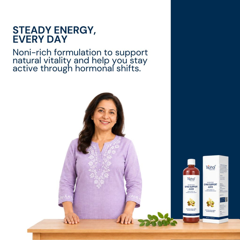 A woman in a light purple embroidered kurta stands behind a wooden table with a bottle and box of Triphal's Gyno Support Juice for Women Wellness on a white and navy promotional background with marketing text.